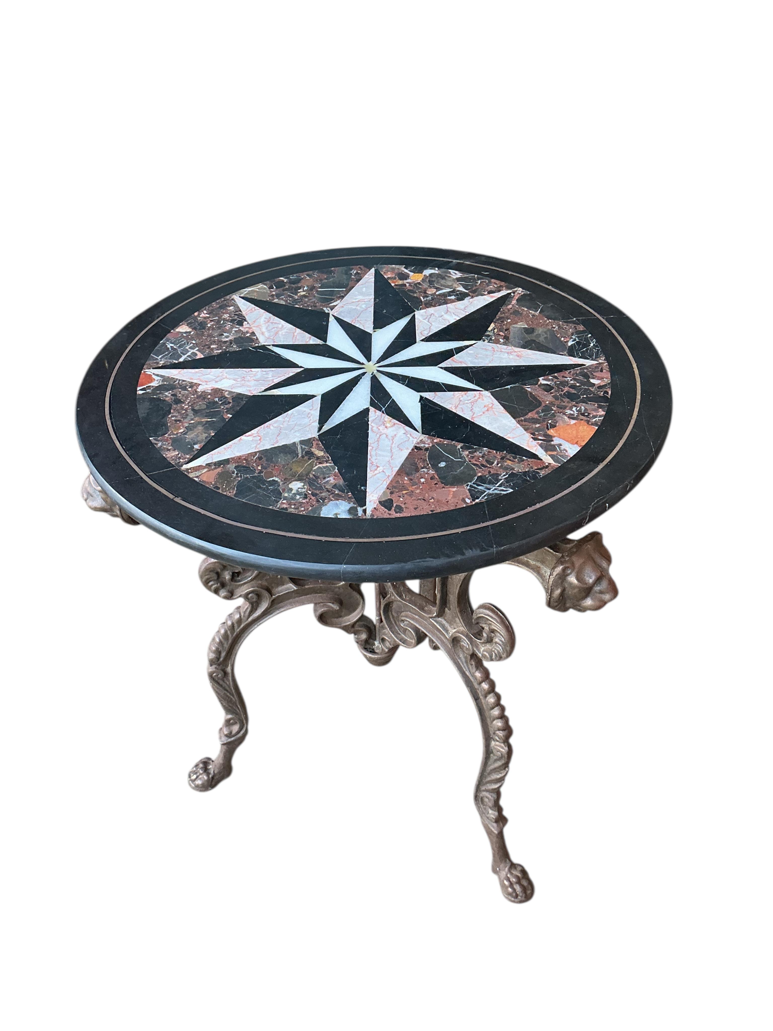 A circular specimen marble top occasional table on cast metal lion mask underframe, diameter 61cm, height 71cm